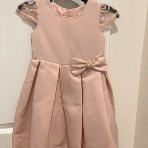 Beautiful mauve colored dress with lace-capped sleeves and high low hem.